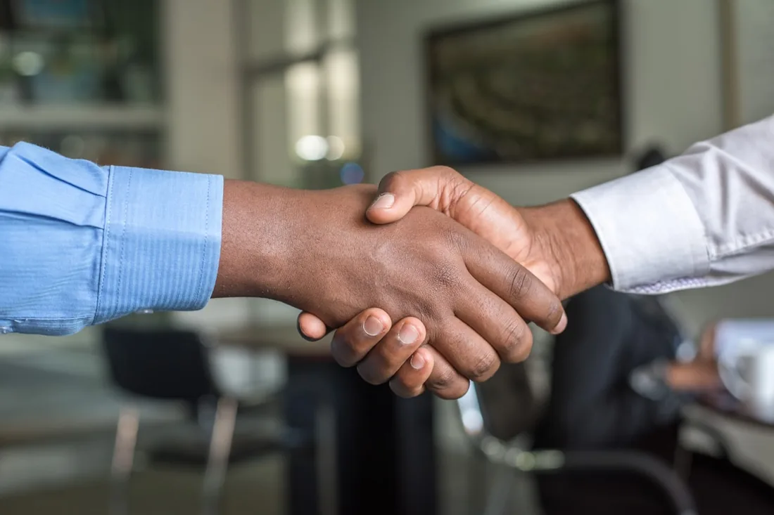Investor and founder handshake representing a closed seed round for B2B startups